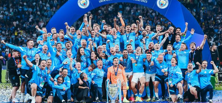 Manchester City's first-team players and staff celebrate after their Champions League final win over Inter Milan in Istanbul