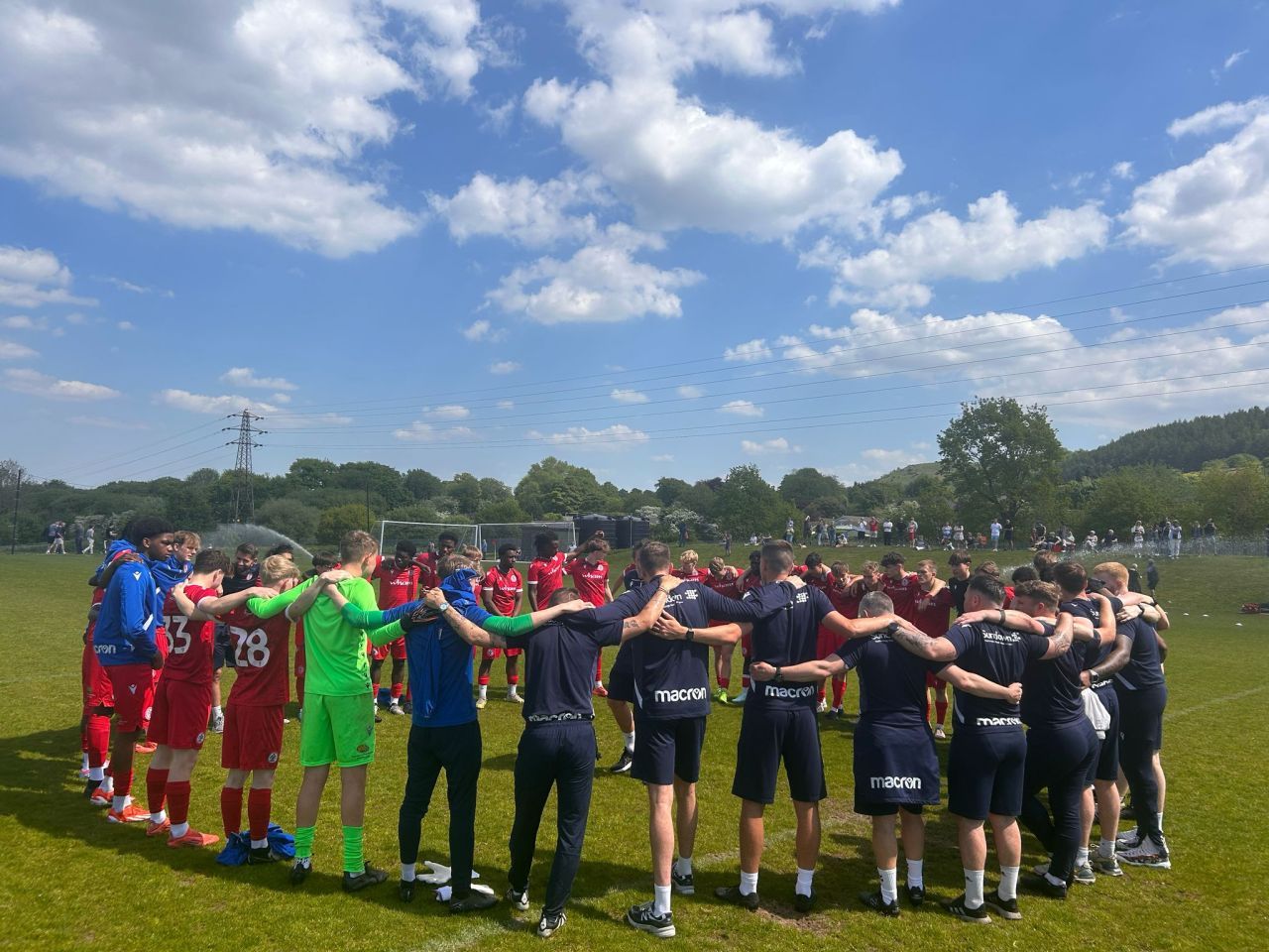 AccringtonStanley2 Accrington Academy players stand in a huddle with their arms around each other's shoulders