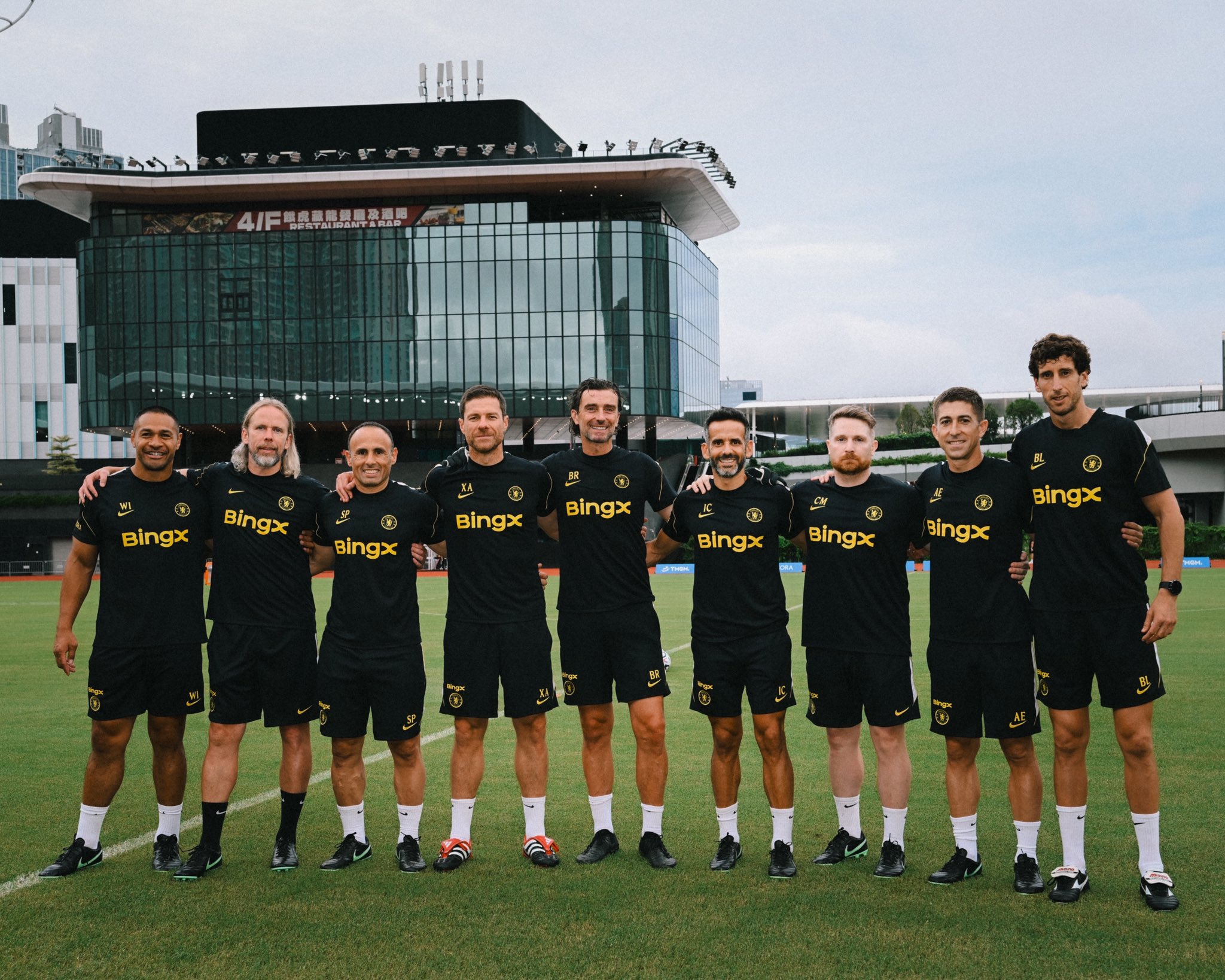 Chelsea staff all in dark coloured kit - (Left to right): Willie Isa, Austin McPhee, Sebas Parrilla, Xabi Alonso, Ben Roberts, Ismael Camenforte, Calum McFarlane, Alberto Encinas, Benat Labaien)